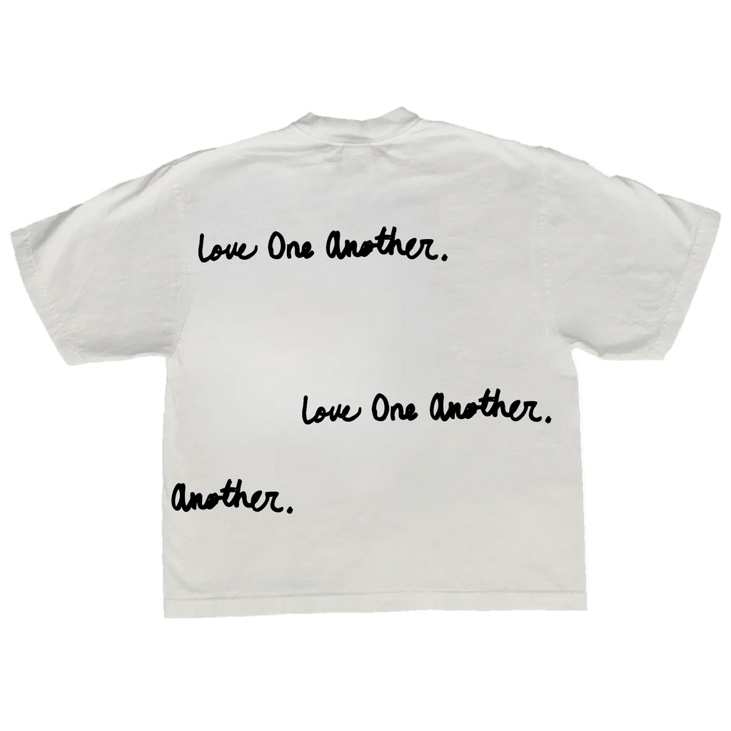 A white short-sleeve t-shirt shown from the back, featuring the phrase 'Love One Another.' printed in black script three times, with the final instance ending in 'Another.